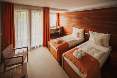 a hotel room with two beds and a desk at Park Holiday Congress & Wellness Hotel in Prague