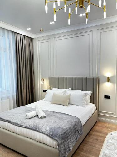 um quarto com uma cama grande com duas toalhas em Talan life aparts em Atyrau