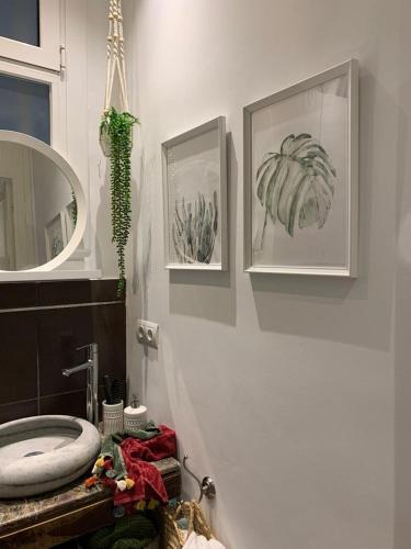 a bathroom with a sink and a mirror at Eixample Apartment in Barcelona