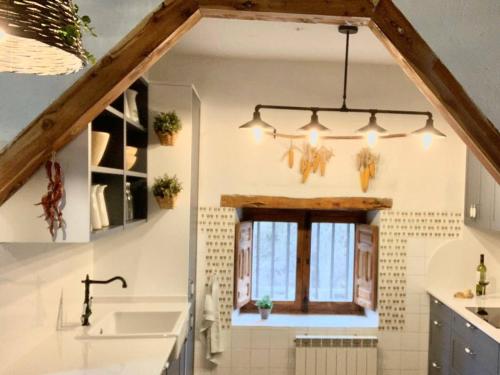 a kitchen with a sink and a window at Molino del Feo in Las Casas Altas