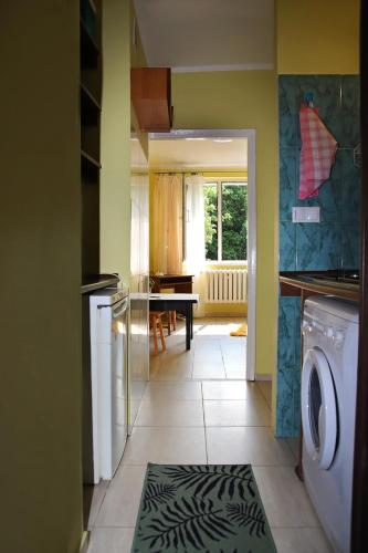 a kitchen with a washing machine and a dining room at Mieszkanie wynajem in Giżycko