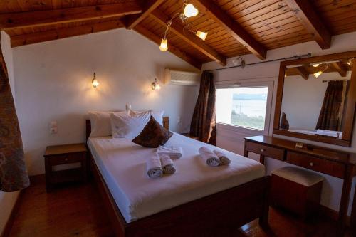 a bedroom with a bed with two towels on it at Voula Resort in Elafonisos