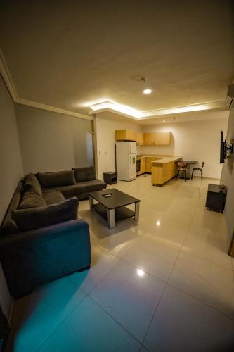 a living room with a couch and a table at Le Caravelle Beirut in Beirut