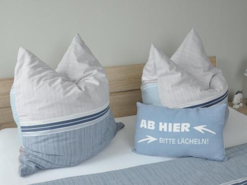 two pillows sitting on top of a bed at Whg 09 - Fischerstuv in Zingst