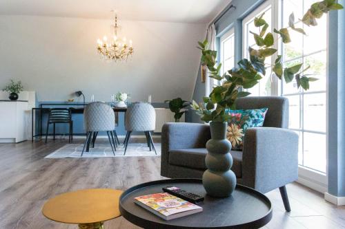 a living room with a couch and a table at JOOYFUL STAYS Apartments in Kevelaer