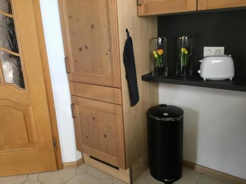 a trash can in a kitchen next to a cabinet at Ferienhaus Barth in Bad Salzungen