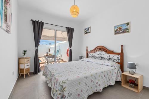 a bedroom with a bed and a view of the ocean at Home2Book Charming Private Pool Puerto del Carmen in Tías