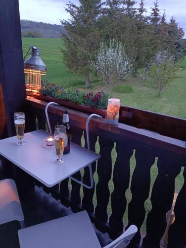 two tables with wine glasses on a balcony with a view at Ferienhaus Barth in Bad Salzungen