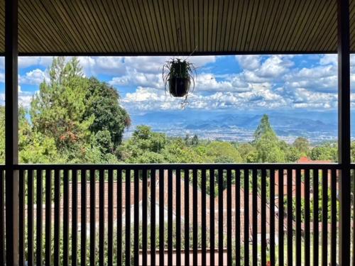 a large window with a view of a forest at Lazuardy Syariah Park and Villa in Bandung