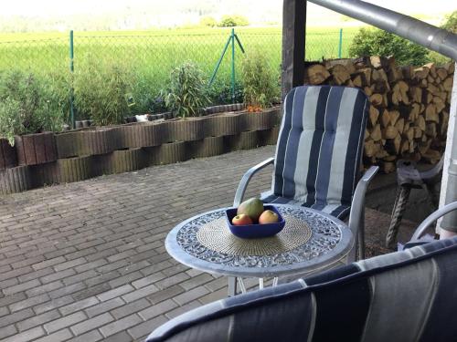 a bowl of fruit on a table on a patio at Ferienhaus Barth in Bad Salzungen