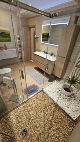 a bathroom with a shower and a sink at Villa Umbra et Sol in Gruda