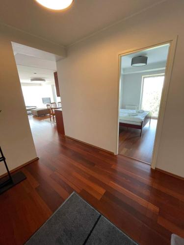 an empty living room with wood floors and a living room at Ringi 37 Riverview Holiday Apartments in Pärnu