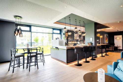 a kitchen and living room with a table and chairs at Premier Inn Berlin Airport in Berlin