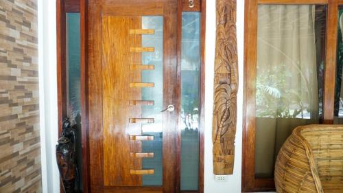 a pair of wooden doors in a room at La Colonial Resort in El Nido