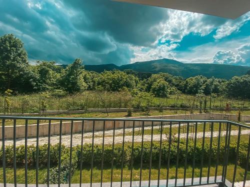 a view of the mountains from a fence at Vitosha View Apartment & Free Parking in Sofia