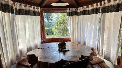 a table in a room with a large window at Ayres del Lago in San Carlos de Bariloche