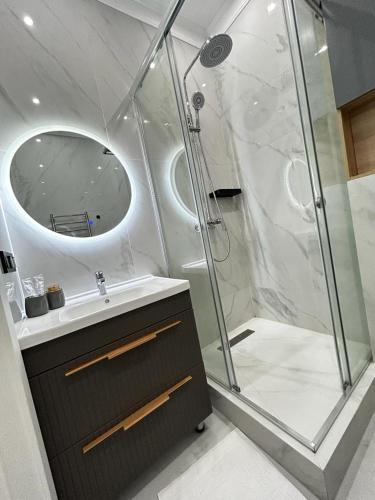 a bathroom with a shower and a sink at Talan life aparts in Atyraū