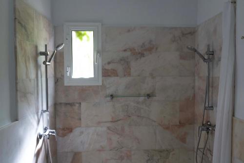 a bathroom with a shower and a window at Hotel Madreselva - Grupo Califa in Los Caños de Meca