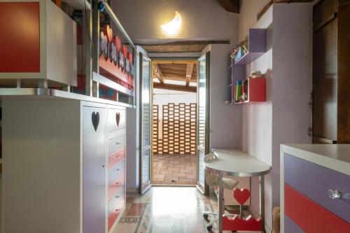 a kitchen with a white refrigerator and a hallway at Spazio seicentesco in Fossombrone