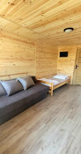 a room with two beds in a wooden cabin at Domki Przy Lesie in Stegna