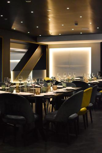 a dining room with tables and chairs with wine glasses at Almanac Barcelona in Barcelona