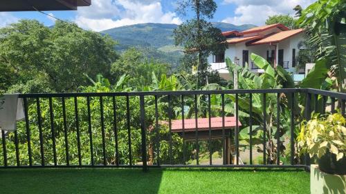 a balcony with a fence and green grass at Moon villa in Kandy