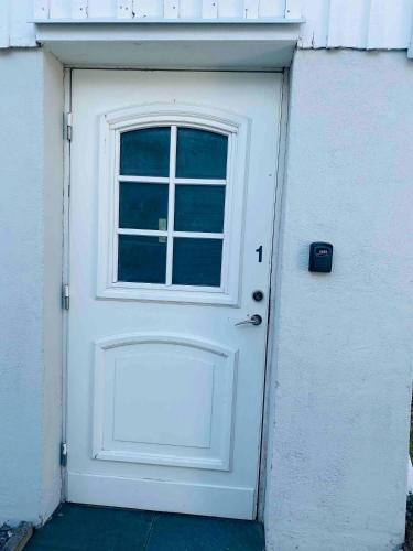 a white door with a window on a building at Lovely 3-bed Flat In Stockholm in Sollentuna