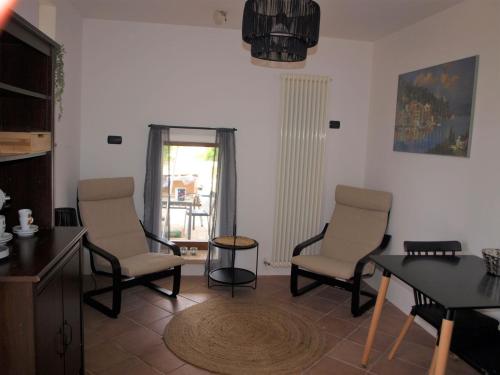 a living room with two chairs and a table at Casale di Maro in Monte Giberto