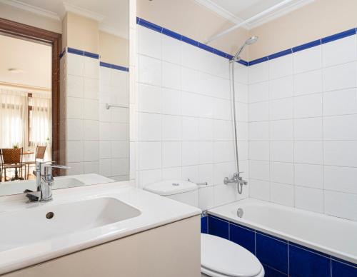 ein Badezimmer mit einem Waschbecken, einem WC und einer Badewanne in der Unterkunft MyHouseSpain - Buen Suceso Apartments in Gijón