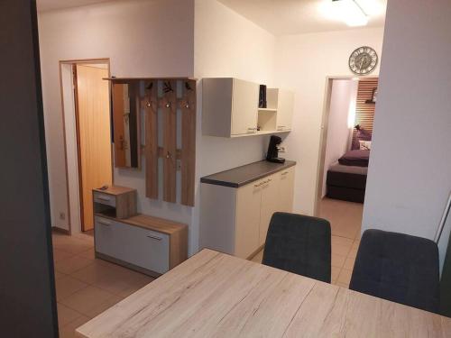 a kitchen and living room with a table and chairs at Ferienwohnung Lina mit toller Terrasse im Schwarzwald in Bernau im Schwarzwald