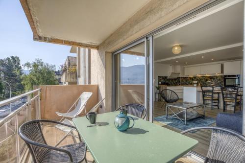 une pièce avec une table et des chaises sur un balcon dans l'établissement Les mats du lac, à Annecy