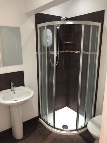 a bathroom with a shower and a sink at Studio Flat in Nottingham