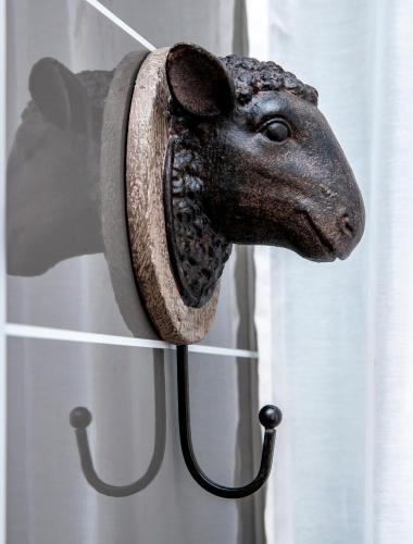 a statue of a dog head hanging on a window at The Fleece Inn in Haworth