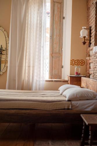 a bed in a room with a window at Dzveli Galavani -Old Wall in Tʼelavi