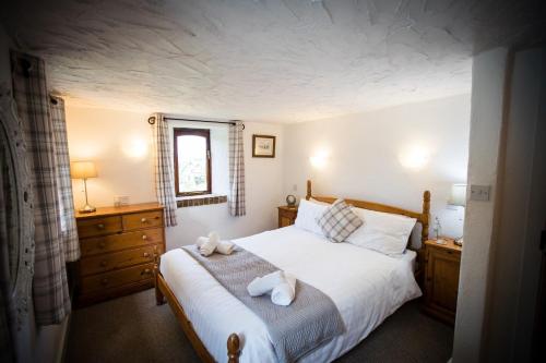 a bedroom with a bed with two towels on it at The Stables at Country Ways in Atherington