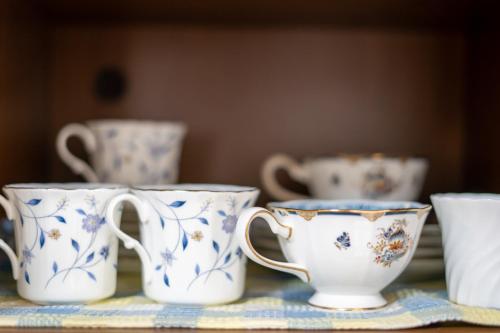 four blue and white cups sitting on a table at Minpaku Ota - Vacation STAY 11960 in Otaru