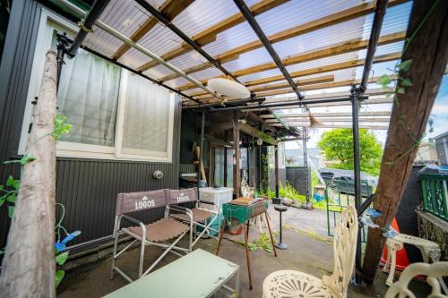 a pergola on a patio with chairs and tables at Minpaku Ota - Vacation STAY 11960 in Otaru