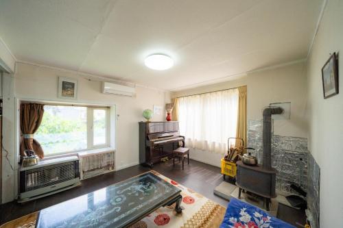 a living room with a large window and a table at Minpaku Ota - Vacation STAY 11960 in Otaru