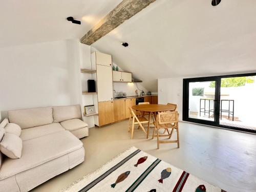 a living room with a couch and a table at Peral Old Town Penthouse II - EaW Homes in Marbella