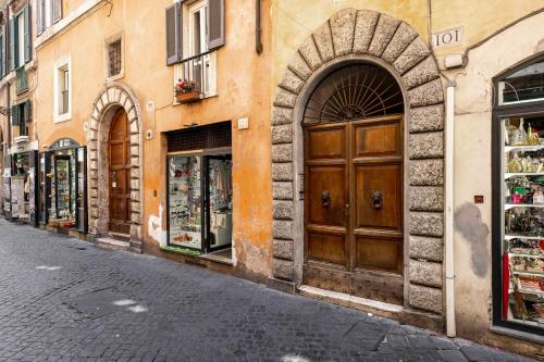 a street in a city with a building with doors at Home at Rome Luxury Navona in Rome