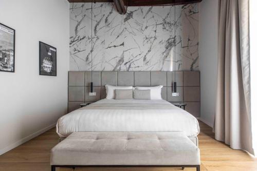 a bedroom with a large bed and a marble wall at Home at Rome Luxury Navona in Rome