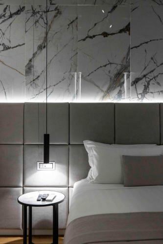 a bedroom with a bed and a table next to it at Home at Rome Luxury Navona in Rome