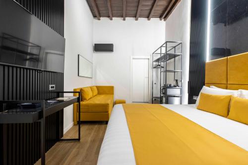 a bedroom with a yellow bed and a yellow chair at Home at Rome Luxury Navona in Rome