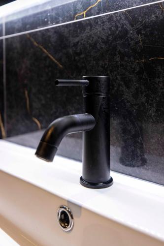 a black water faucet on a window sill at Home at Rome Luxury Navona in Rome