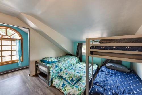 a bedroom with two bunk beds and a window at Waterfront Fox Lake Vacation Rental with Fire Pit! in Fox Lake