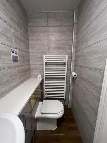 a small bathroom with a toilet and a sink at Hartington House in Middlesbrough