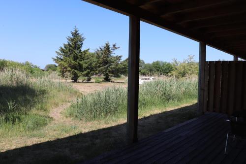 a screened porch with a view of a field at Halbinsel Resort Peenemünde in Peenemünde
