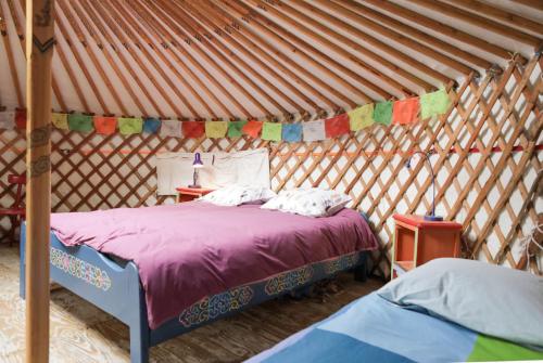 a bedroom with two beds in a yurt at La Yourte du Masfranc in Latour-de-Carol