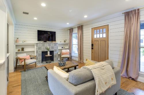 a living room with a couch and a fireplace at Pecan Blue Frisco Home with Private Yard and Hot Tub in Frisco