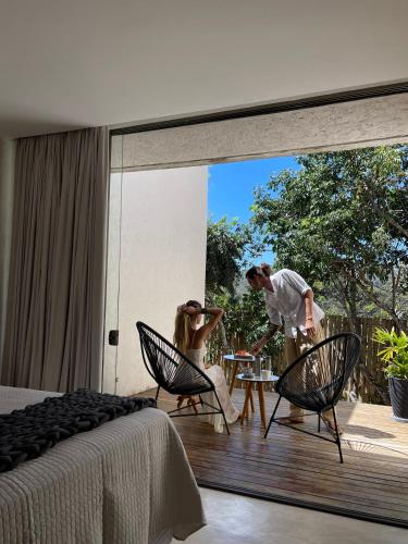 two people are standing on a deck with a bedroom at Statera Host in Alto Paraíso de Goiás